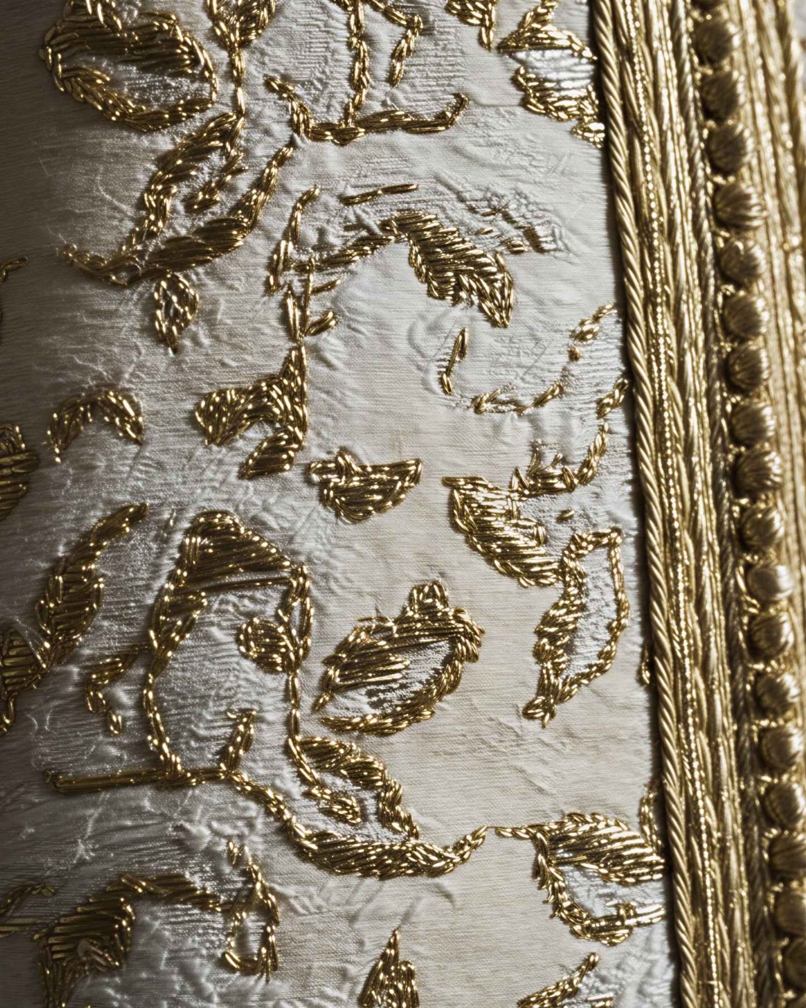 Ivory Dawn kaftan close-up of gold embroidered motifs on ivory fabric