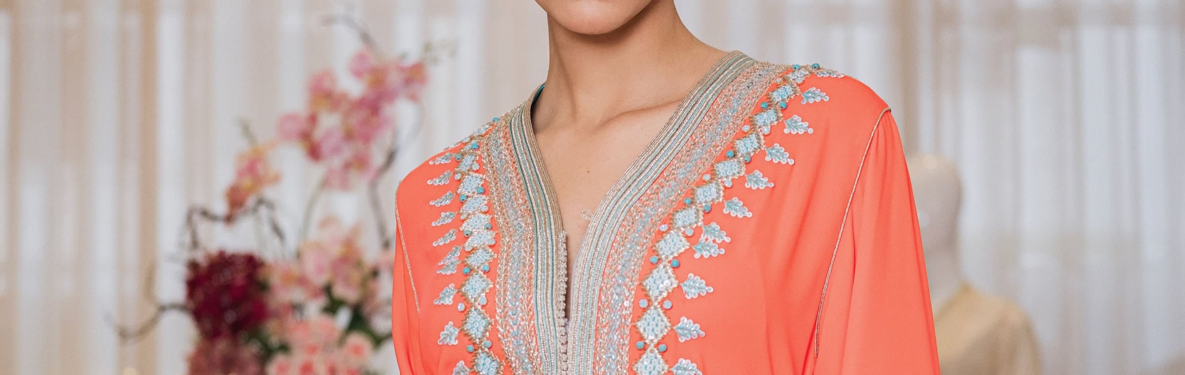 Persimmon one-piece Moroccan caftan with a silver hand-worked braid from collar to hem