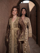 Bronze Reverie lamé organza Moroccan kaftan with gold embroidery, worn open over a champagne dress, shown alongside a second look
