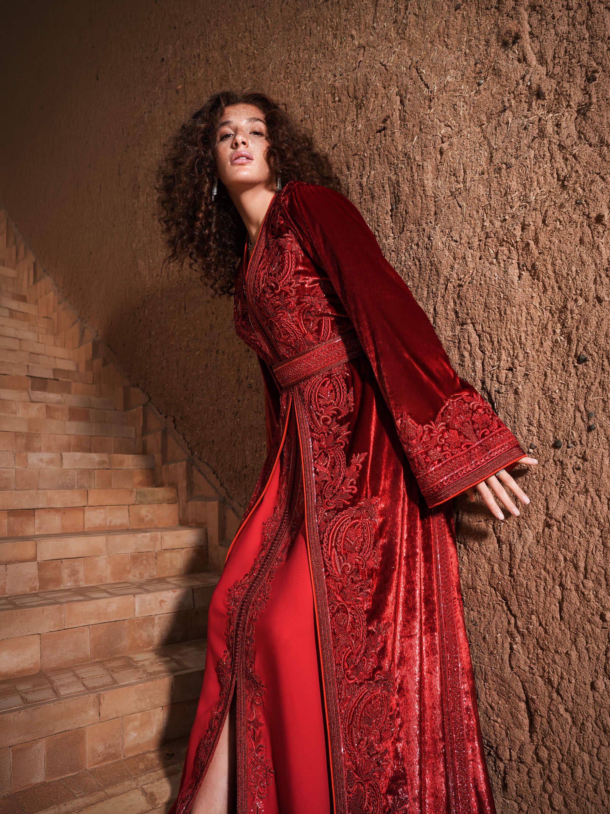 Garnet Adagio burgundy velvet Moroccan kaftan with tone-on-tone embroidery, matching belt and wide sleeves, full-length view