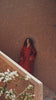 Carmine Cadence red crepe Moroccan kaftan with sequined paisley embroidery, braided belt and flared sleeves, in motion