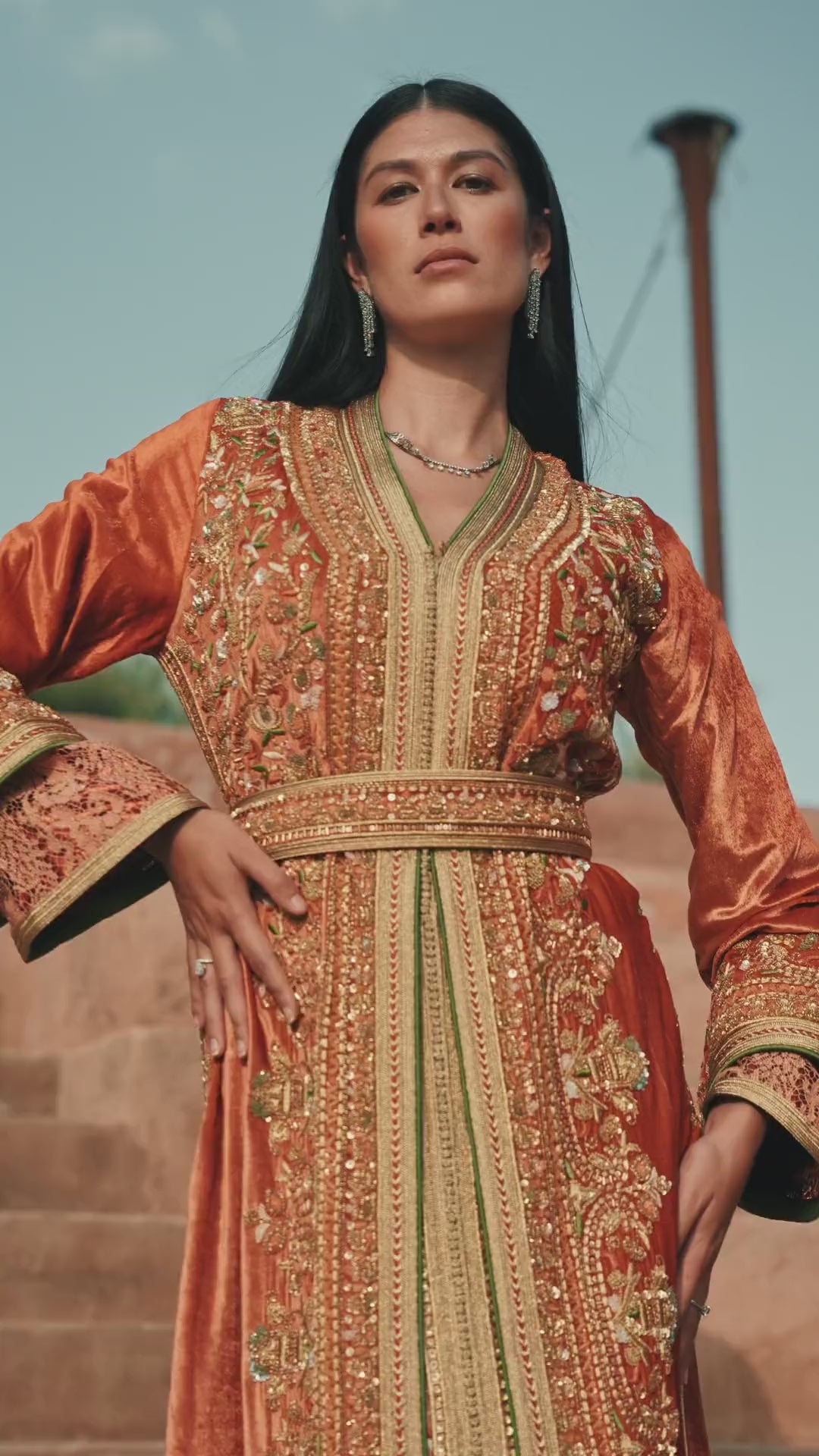 Terracotta Zenith rust velvet Moroccan kaftan with gold and green embroidery, in motion